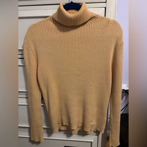 Woman’s Tan Turtleneck Sweater